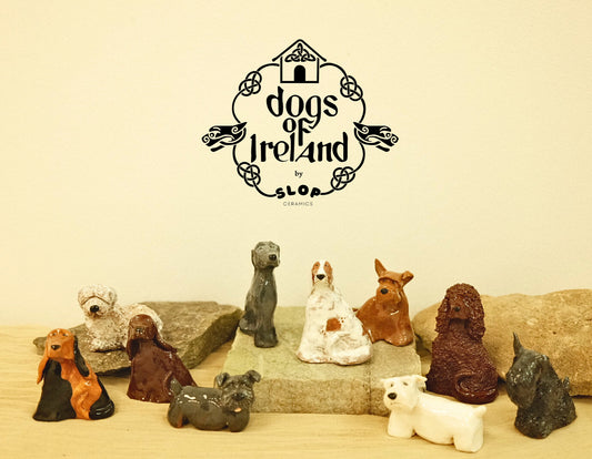 Collection of ceramic dog figurines with 'dogs of Ireland' branding on a beige background.